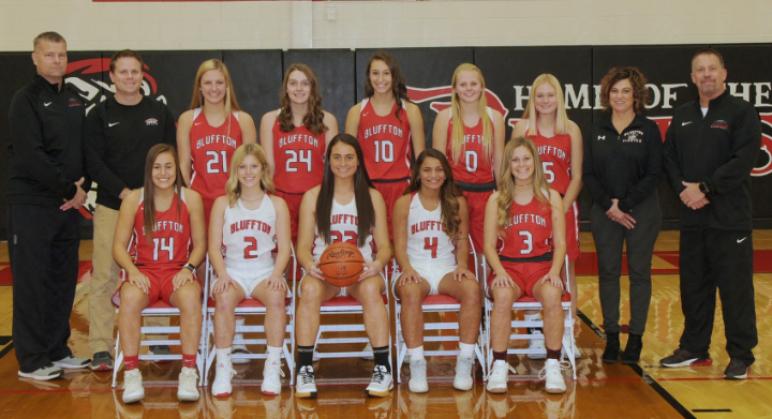 Varsity Girls' Basketball - Row 1 (left to right): Riley Busch, Brinkley Garmatter, Libby Schaadt, Kayla White, Laykin Garmatter. - Row 2 (left to right): Coach Gleason, Coach Dunlap, Sophie Bricker, Kylie Monday, Kylie Stackhouse, Haelyn Bischoff, Reagan Mittendorf, Coach Lee, Coach Garmatter.