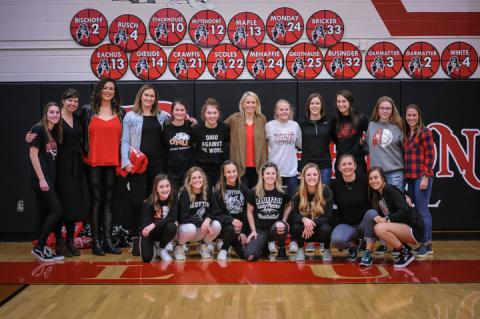 1999-2000 team with members of this year's girls' basketball team.