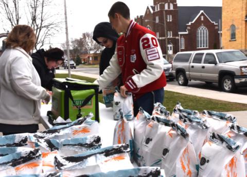 Nathan Taylor, 8th grader, and Zachary Taylor, senior, pick up their lunches