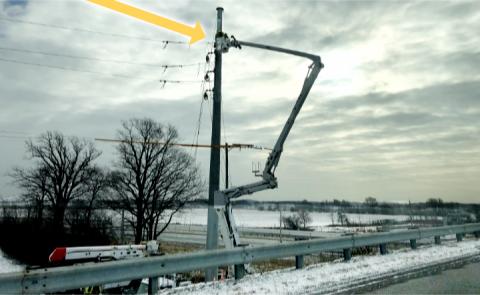 Electrical workers in high spot, bitter temperatures