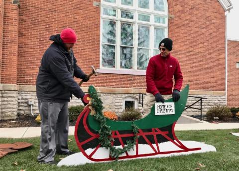 Volunteers set up Ream folk art display