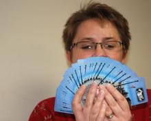 Melinda Bowden of PromoHits! looks at her card hand