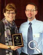 Dr. Lucia Unrau is awarded the Ohio Music Teachers Association Collegiate Teacher of the Year award by Dr. Michael Benson, Certification Chair of OhioMTA.