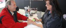 Joan Fredericks gives a manicure to  Jeff Boehr, owner of the building housing Polished Nail and Body Salon