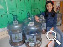 Third grader Annalise Nisly with the pennies collected so far