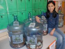 Third grader Annalise Nisly with the pennies collected so far