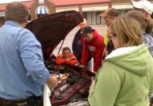 Doug Kisseberth (left) explains how to jump start a car