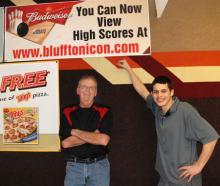 John Dailey and Derek Dukes show off the Bluffton Icon poster at Southgate Lanes