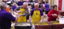 Lions Club members serving barbecue chicken dinners