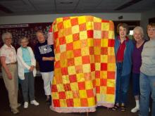 From left Joyce Hostetler, Wanda Pannabecker, Libby Hostetler, Arlene Geiser, Joan Bauman and Fran Core with quilt.