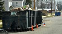 Dumpsters on Cherry Street show the results of flooding