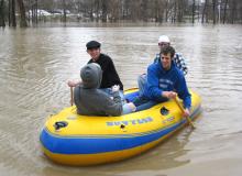 Four Bluffton University students boated across the Riley from Bren-Dell to Centennial Hall. In the black hat is Bracton Eicher from Berne, Ind. IN the blue sweatshirt is Aaron Yost from Arizona. The other two are not identified. Hanna Mattingly photo.