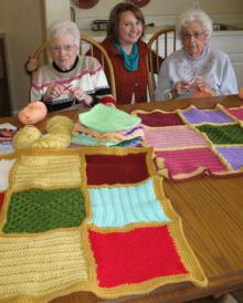 Betty Engle, Kimberly Hansen, Mary Huffer with baby blankets