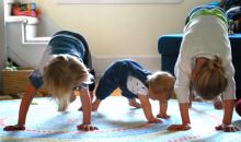 Adeline, Leo and Ella Heiks demonstrate the Downward Dog