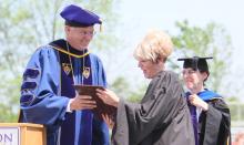 Bluffton University President James M. Harder presents Karel Oxley, superintendent of Lima City Schools, with an honorary doctorate of humane letters prior to her commencement address at Bluffton on May 6. Looking on is Dr. Sally Weaver Sommer, vice president and dean of academic affairs.