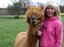 Dr. Cheryl DeWitt stands with her alpaca, who will be part of the Earth Day blessing of animals.